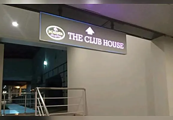 A lit shop sign at night